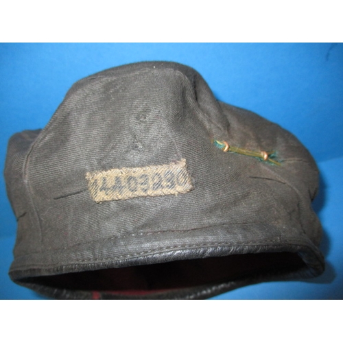 218 - A 1944 parachute regiment maroon Kangol beret and cap badge, 7th light infantry, in good used condit... 