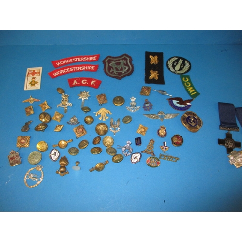 219 - A parcel of WWII and later military and civilian insignia and some replica medals, all in used condi... 