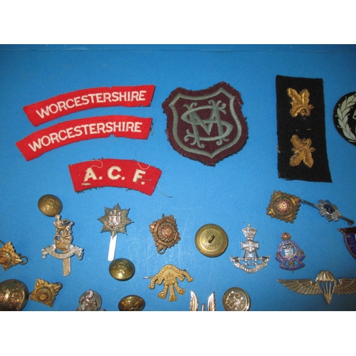 219 - A parcel of WWII and later military and civilian insignia and some replica medals, all in used condi... 