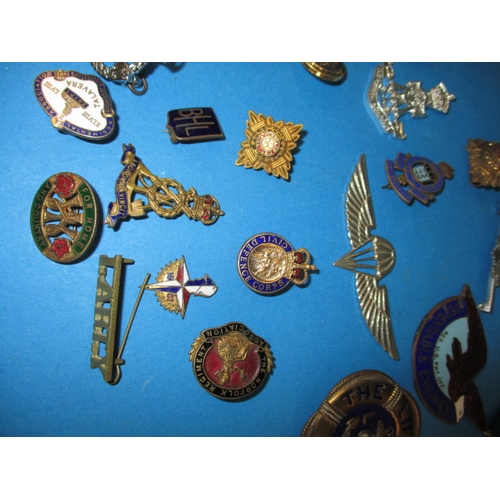 219 - A parcel of WWII and later military and civilian insignia and some replica medals, all in used condi... 