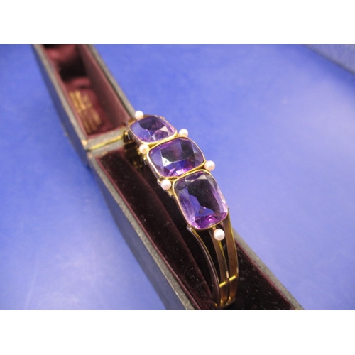 100 - A vintage yellow metal bracelet, having 3 large amethyst coloured stones, approx. weight 19.8g in us... 