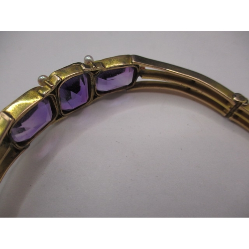 100 - A vintage yellow metal bracelet, having 3 large amethyst coloured stones, approx. weight 19.8g in us... 