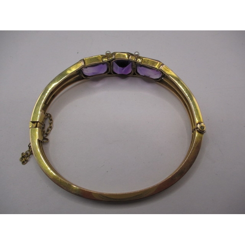 100 - A vintage yellow metal bracelet, having 3 large amethyst coloured stones, approx. weight 19.8g in us... 