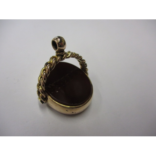 104 - A 9ct gold rotating hard stone pendant, in useable pre-owned condition