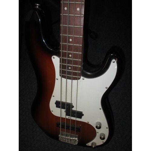 308 - A Squier by Fender precision electric bass guitar, with a Hercules guitar stand. In pre-owned condit... 