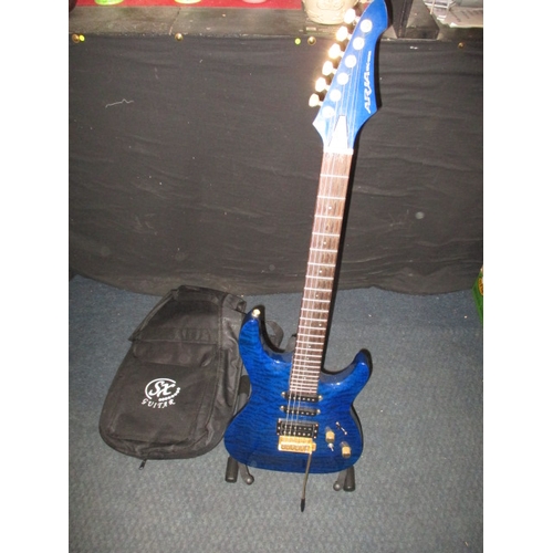 An Aria MAC-series electric guitar, with stand and soft carry case. In pre-owned condition
