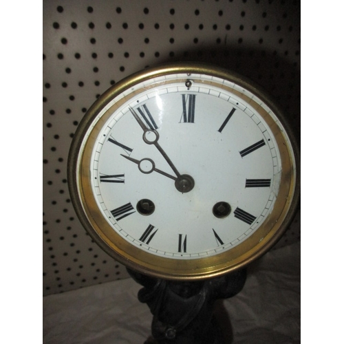 233 - A vintage 2 train mantel clock, the movement held aloft by a cast metal cherub, no key so not tested... 