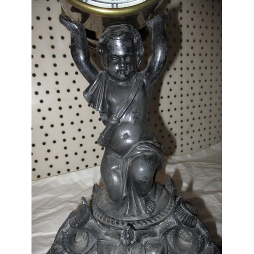 233 - A vintage 2 train mantel clock, the movement held aloft by a cast metal cherub, no key so not tested... 