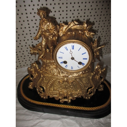 235 - A vintage continental 2 trail mantle clock, with gilt painted metal case under glass dome, no key so... 