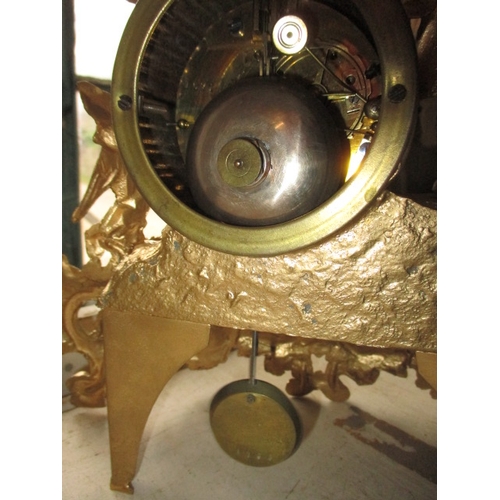 235 - A vintage continental 2 trail mantle clock, with gilt painted metal case under glass dome, no key so... 