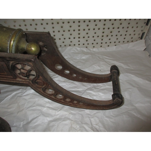 296 - A vintage brass and iron table top cannon and a quantity of iron balls, all in used condition, appro... 