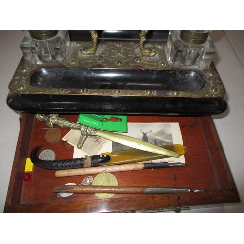 298 - An Edwardian two bottle standish and a brass mounted blotter, all in used condition with general use... 