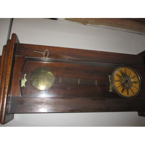 240 - A vintage oak cased wall clock, approx. length 93cm, having use-related marks runs when wound