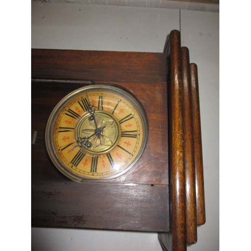 240 - A vintage oak cased wall clock, approx. length 93cm, having use-related marks runs when wound