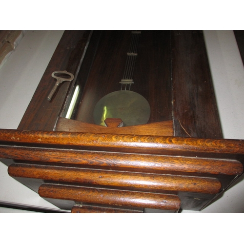 240 - A vintage oak cased wall clock, approx. length 93cm, having use-related marks runs when wound