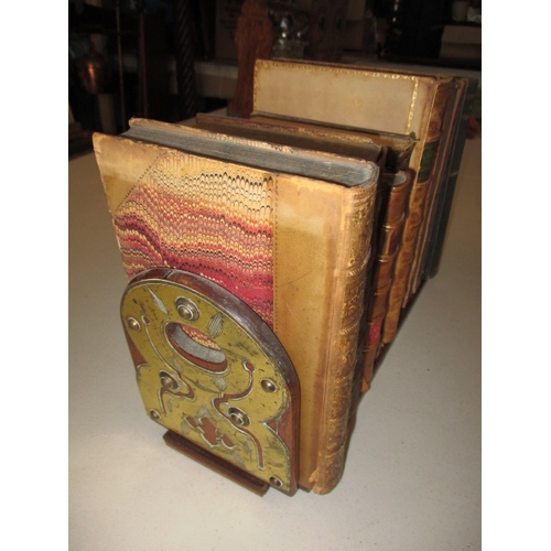 302 - A vintage brass mounted book slide with a quantity of old books, in useable pre-owned condition