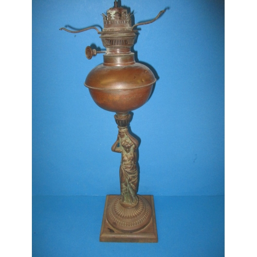 306 - An antique cast iron figural oil lamp, having copper reservoir, use and age related marks, no shade