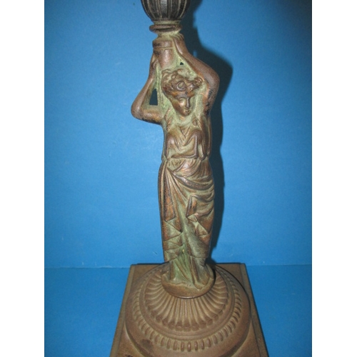 306 - An antique cast iron figural oil lamp, having copper reservoir, use and age related marks, no shade