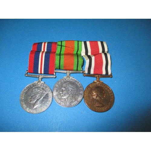 215 - A WWII medal duo and a police service medal named to Raymond Sanderson, in good used condition