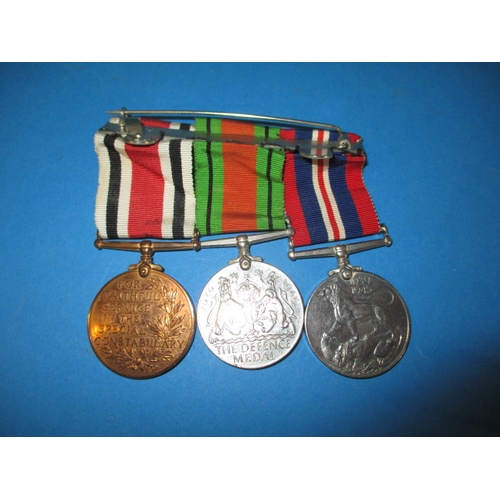 215 - A WWII medal duo and a police service medal named to Raymond Sanderson, in good used condition