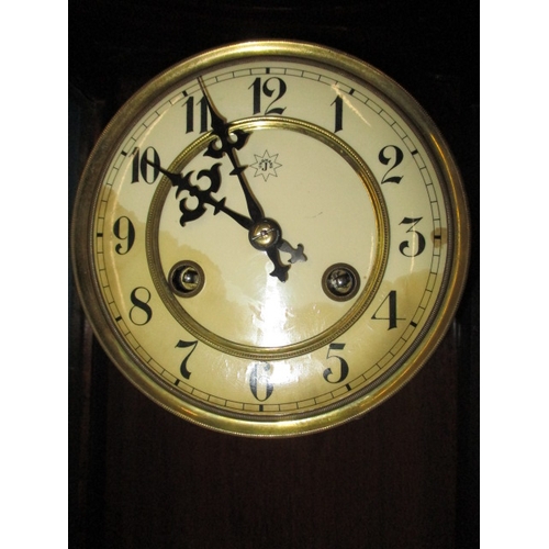 241 - An early 20th century mahogany cased wall clock, in current working order, approx. length 83cm, havi... 