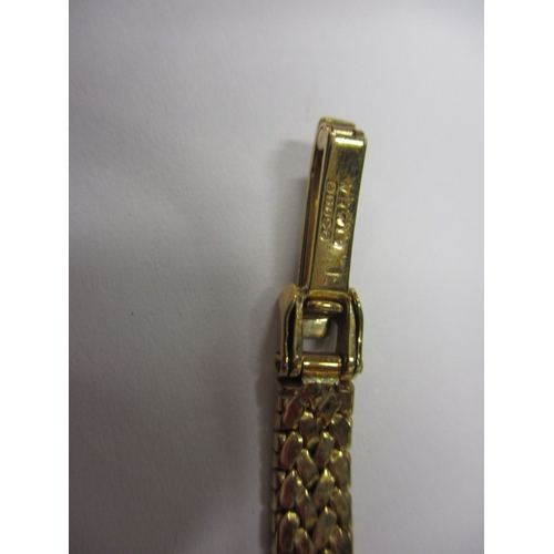 84 - A 9ct yellow gold ladies wrist watch with integral gold strap, marked Garrard, in original box, requ... 