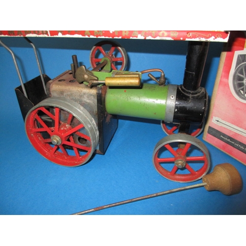 301 - A vintage Mamod TE1 live steam traction engine, with fire pan, steering rod and box, in used conditi... 