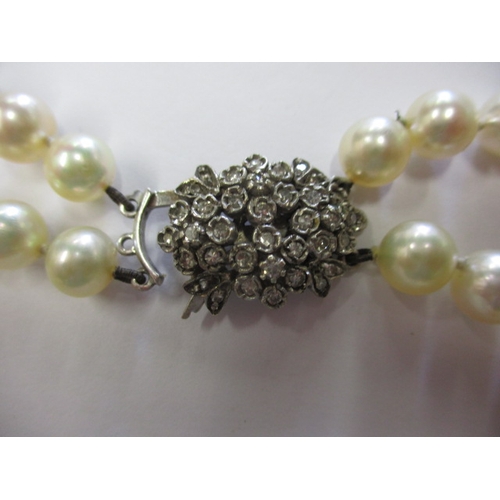 140 - A vintage 2 strand pearl necklace with 9ct diamond set clasp, approx. linear length 46cm, approx. be... 