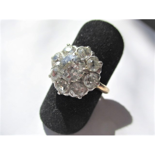 15 - A vintage 18ct yellow gold diamond cluster ring, approx. size of central stone 6.75mm, the 8 other s... 