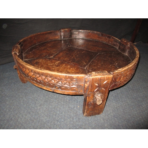 282 - An antique Indian hand carved grain bowl/table, raised on 4 short legs, approx. diameter 76cm in use... 