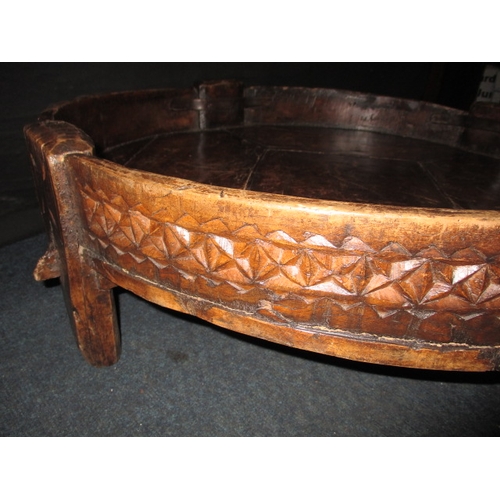 282 - An antique Indian hand carved grain bowl/table, raised on 4 short legs, approx. diameter 76cm in use... 