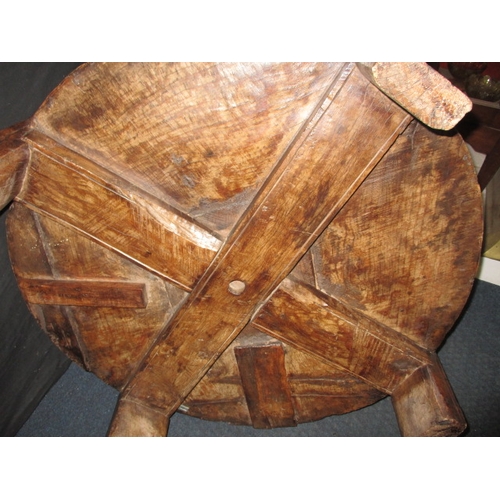 282 - An antique Indian hand carved grain bowl/table, raised on 4 short legs, approx. diameter 76cm in use... 