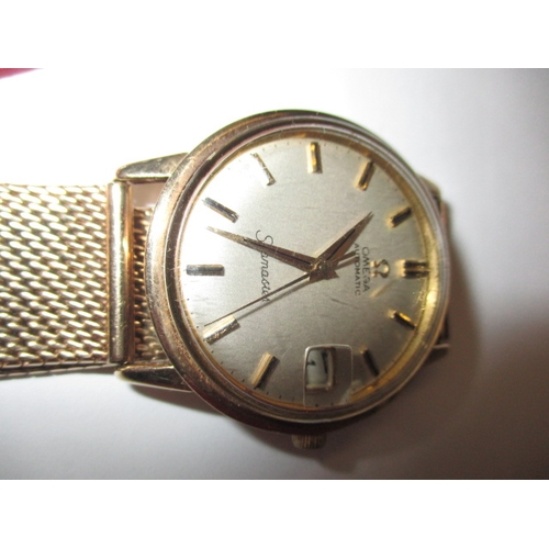 88 - A late 1960’s gold cased Omega automatic Seamaster watch, with 9ct gold mesh strap and date window, ... 