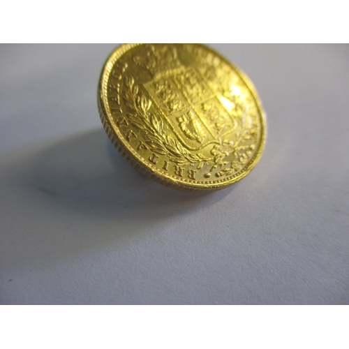 120 - A Victorian gold shield back sovereign dated 1853, a circulated coin with good definition of feature... 