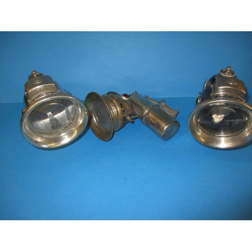 254 - 3 Vintage carbide cycle lamps, all with original mounting brackets, in used condition with age-relat... 