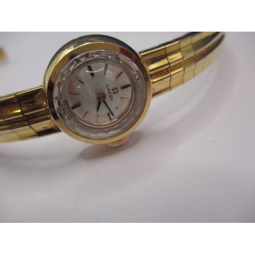 93 - A vintage gold ladies omega wrist watch, with integral strap marked 750, approx. gross weight 34.8g ... 