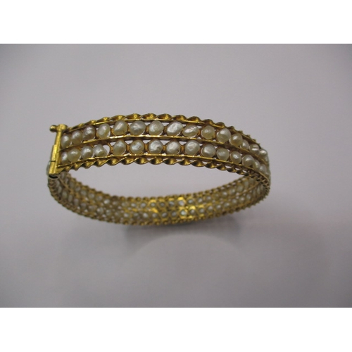 62 - A Bahrain gold and natural seed pearl bangle, clasp pin is stiff, approx. gross weight 19.4g, in vin... 