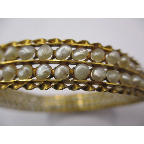 62 - A Bahrain gold and natural seed pearl bangle, clasp pin is stiff, approx. gross weight 19.4g, in vin... 