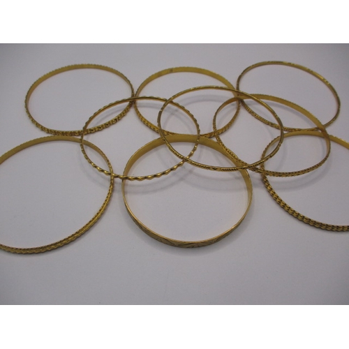 63 - Bahrain gold bangles, 9 in total, all different designs and widths, approx. gross parcel weight 99.7... 