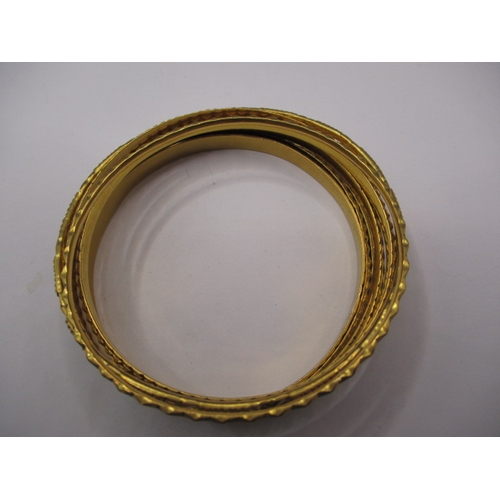 63 - Bahrain gold bangles, 9 in total, all different designs and widths, approx. gross parcel weight 99.7... 