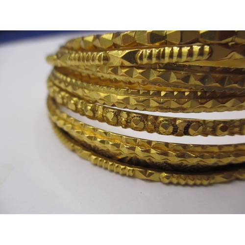 63 - Bahrain gold bangles, 9 in total, all different designs and widths, approx. gross parcel weight 99.7... 