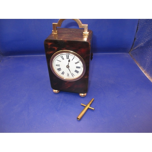 185 - An antique travel clock with hallmarked gold mounts, in current working order striking the hours. Ap... 