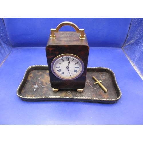 185 - An antique travel clock with hallmarked gold mounts, in current working order striking the hours. Ap... 