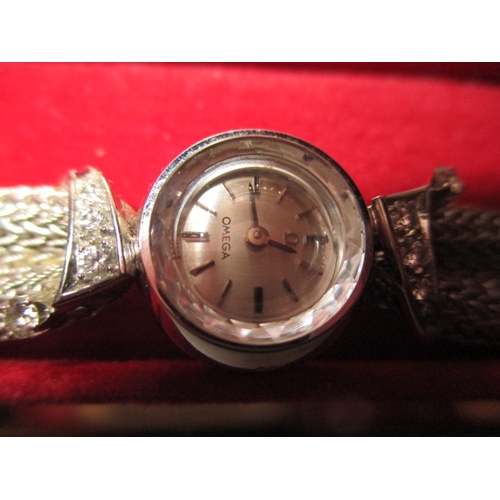 94 - A vintage Omega white gold ladies evening watch,  marked 750 and set with 4 diamonds to each shoulde... 