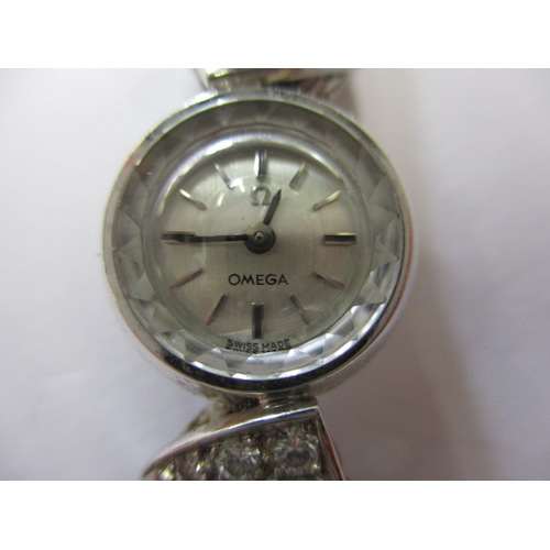 94 - A vintage Omega white gold ladies evening watch,  marked 750 and set with 4 diamonds to each shoulde... 