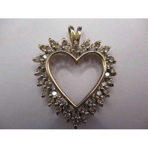 69 - A 9ct yellow gold and diamond heart shaped necklace pendant, approx. total diamond ct weight being 1... 