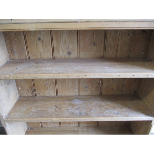 294 - A 19th century waxed pine wall mounted kitchen unit, consisting of shelves above doored cabinet, app... 