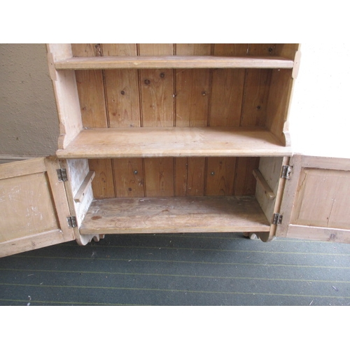 294 - A 19th century waxed pine wall mounted kitchen unit, consisting of shelves above doored cabinet, app... 