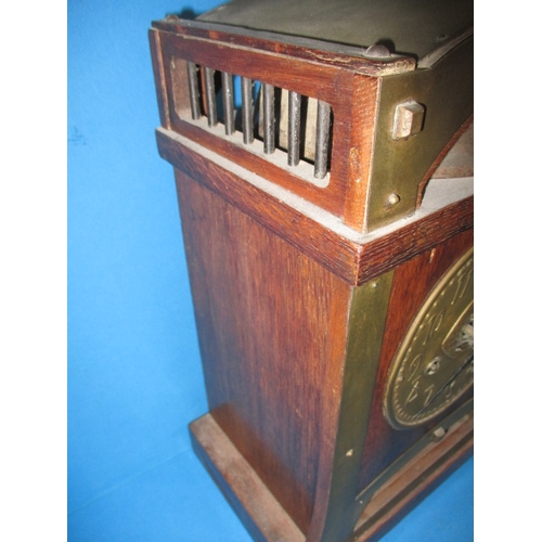 285 - An early 20th century Arts & Craft mantle clock, striking on a  bell with oak and brass body, with k... 