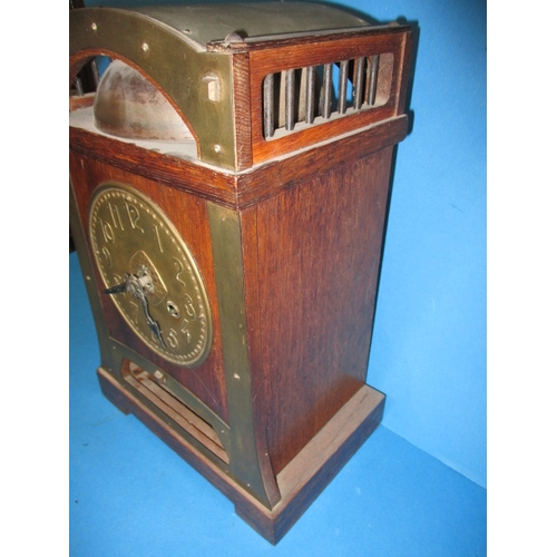 285 - An early 20th century Arts & Craft mantle clock, striking on a  bell with oak and brass body, with k... 